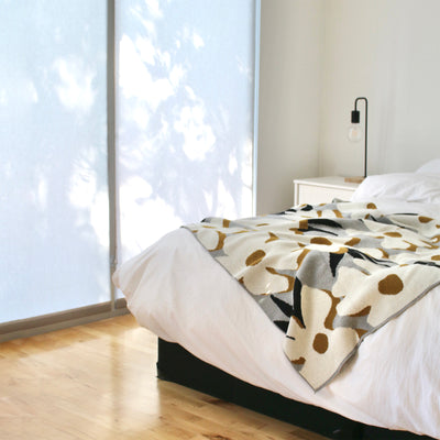 Minimalist Bedroom with Flower Throw at the foot of the bed