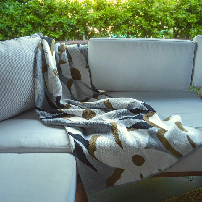 Patio Sofa with Grey Flower Throw