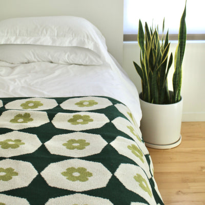 Green Geometric Throw on a White Bed