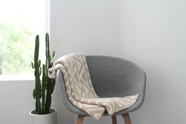 Beige Subtle Pattern Modern Cotton Throw on a Hay Chair