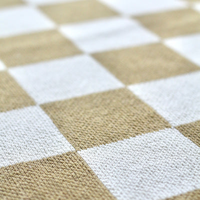 Close Up of Tan and White Checkered Throw
