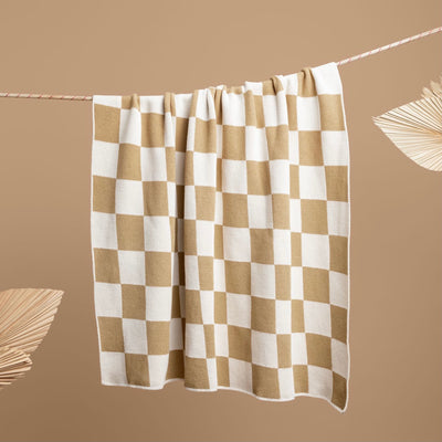 Tan And White Checkered Throw Hanging on a Rope