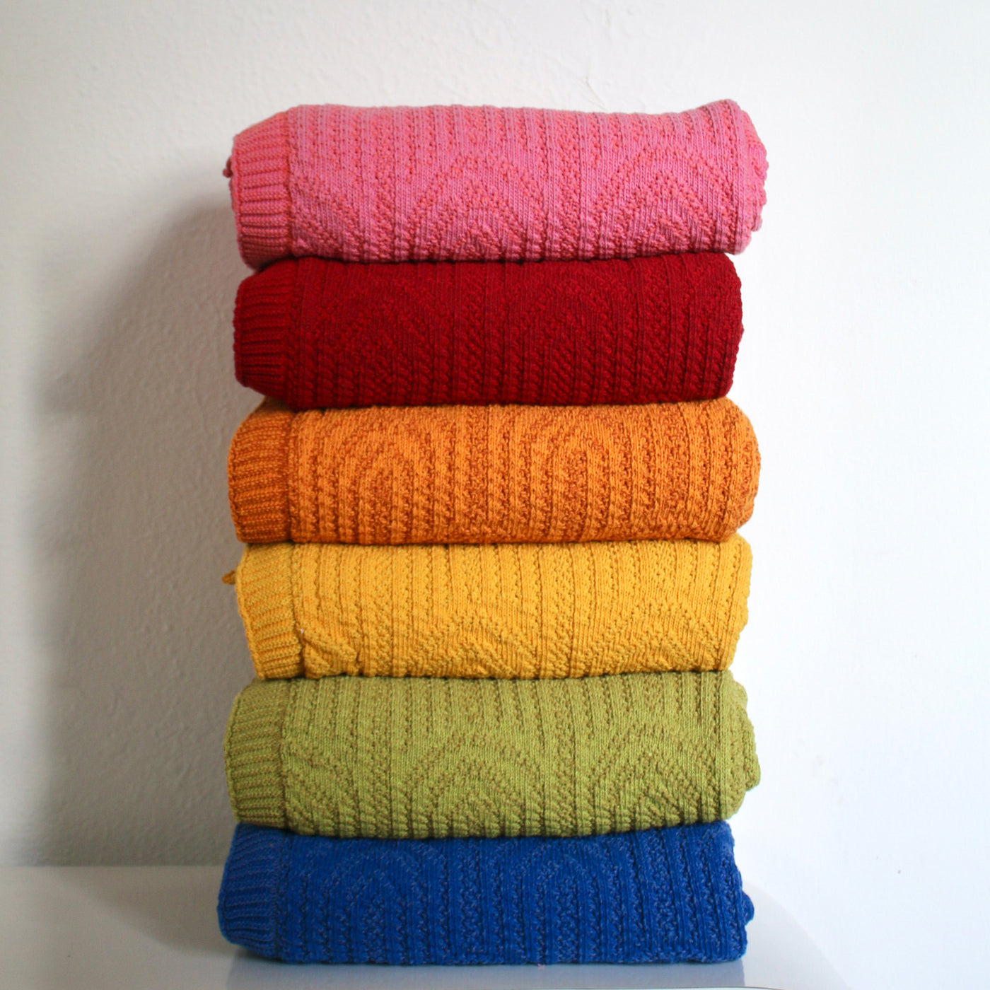 A Stacked Rainbow of Cotton Throw Blankets