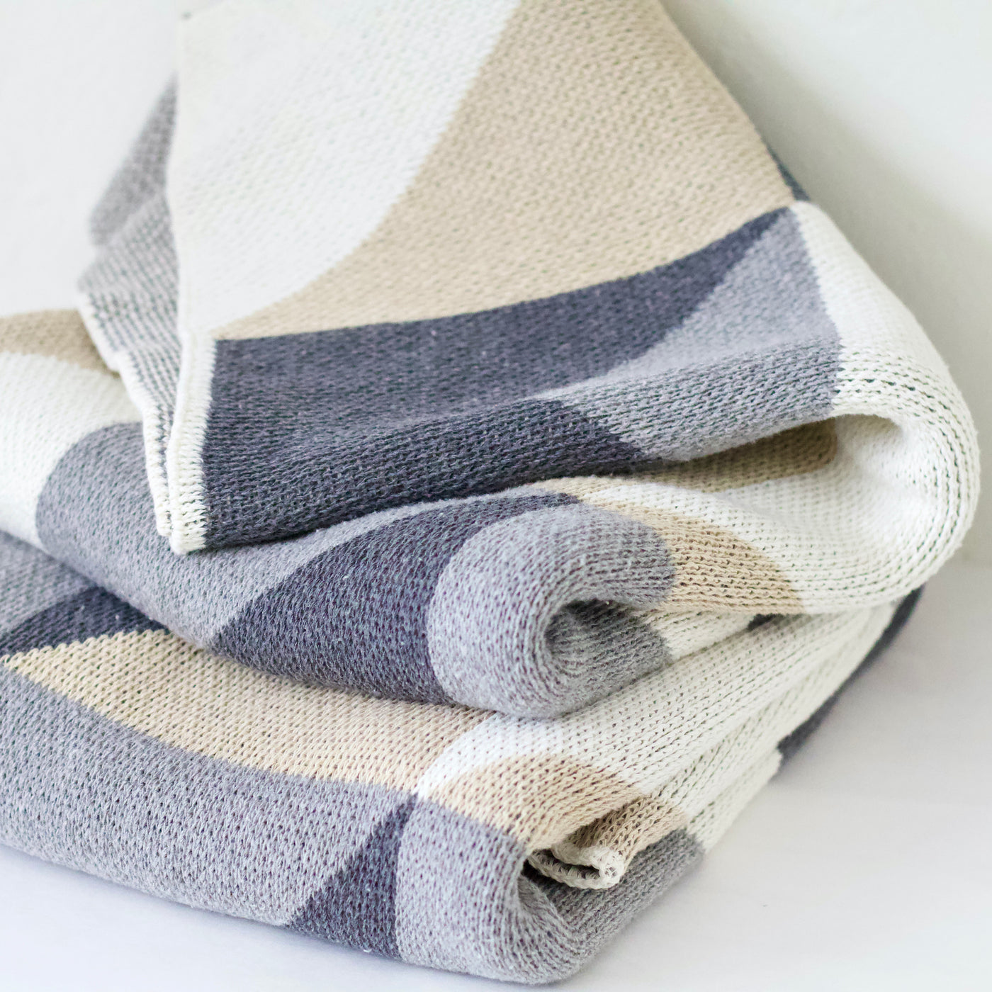 Folded Beige and Grey Soft Throw