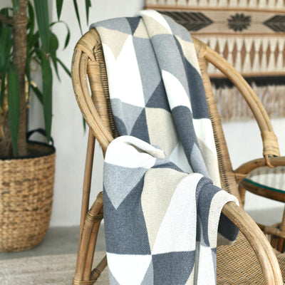 Grey and Beige Patterned Throw on Rattan Chair