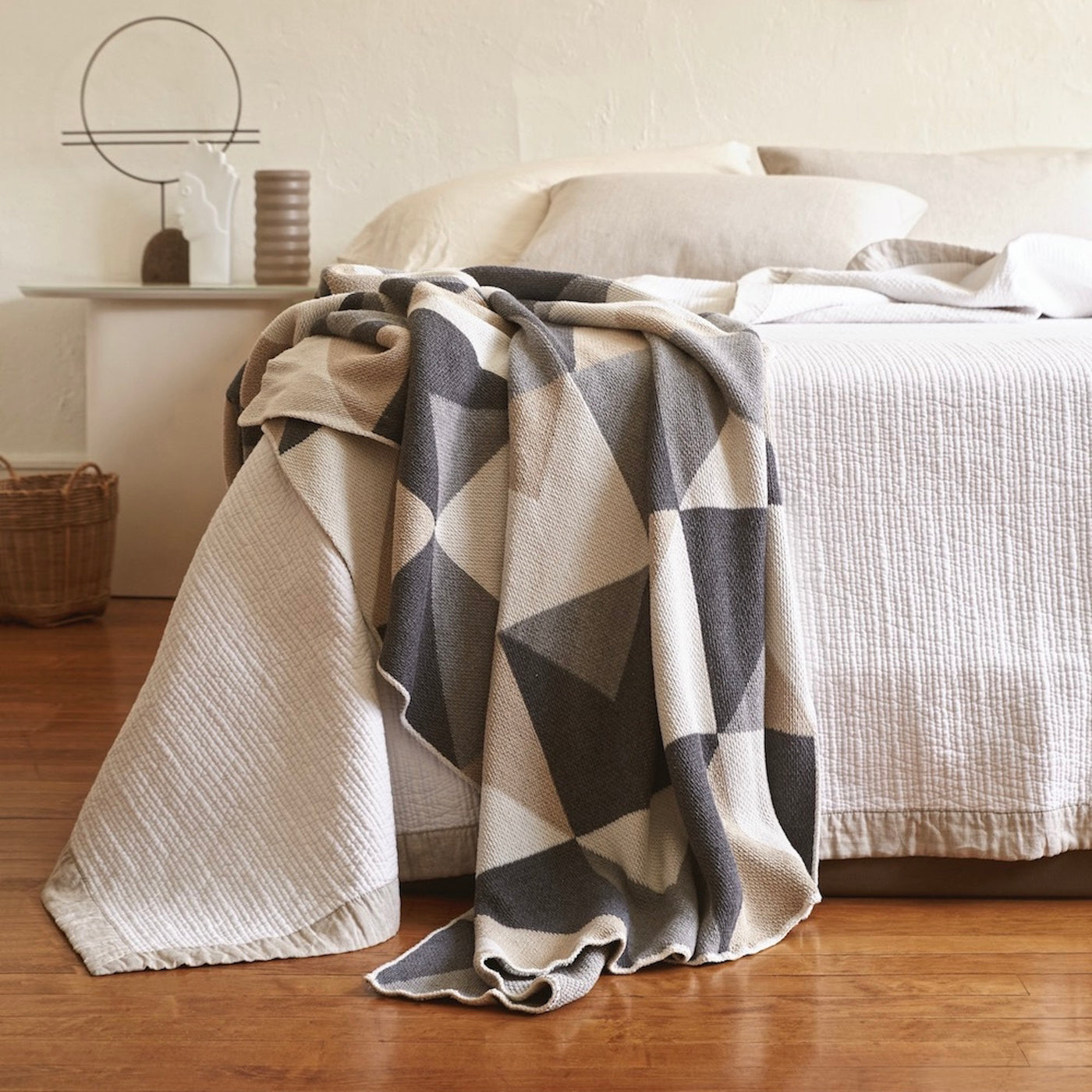 White Bed with Grey and Beige Patterned Throw 