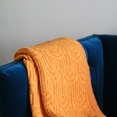 Orange Arch Throw on a Blue Couch