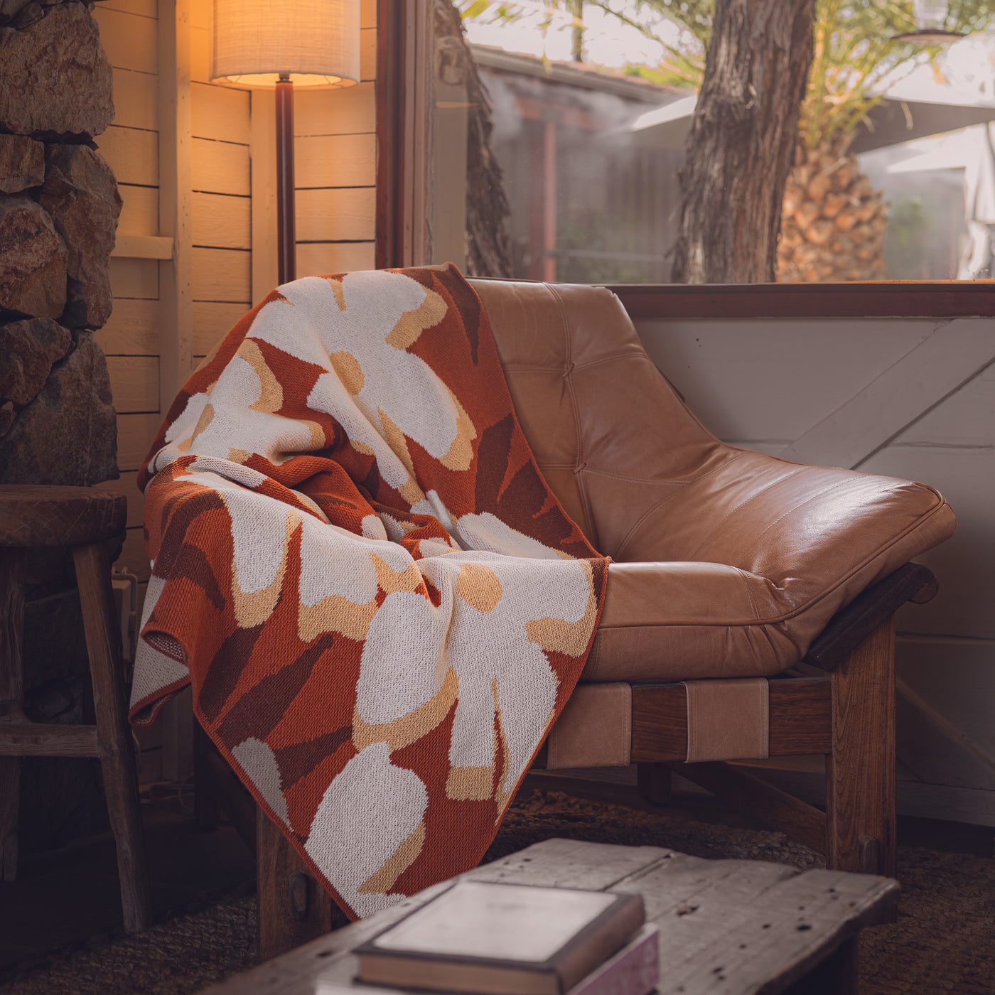 Rust Flower Throw Blanket on Camel Leather Chair