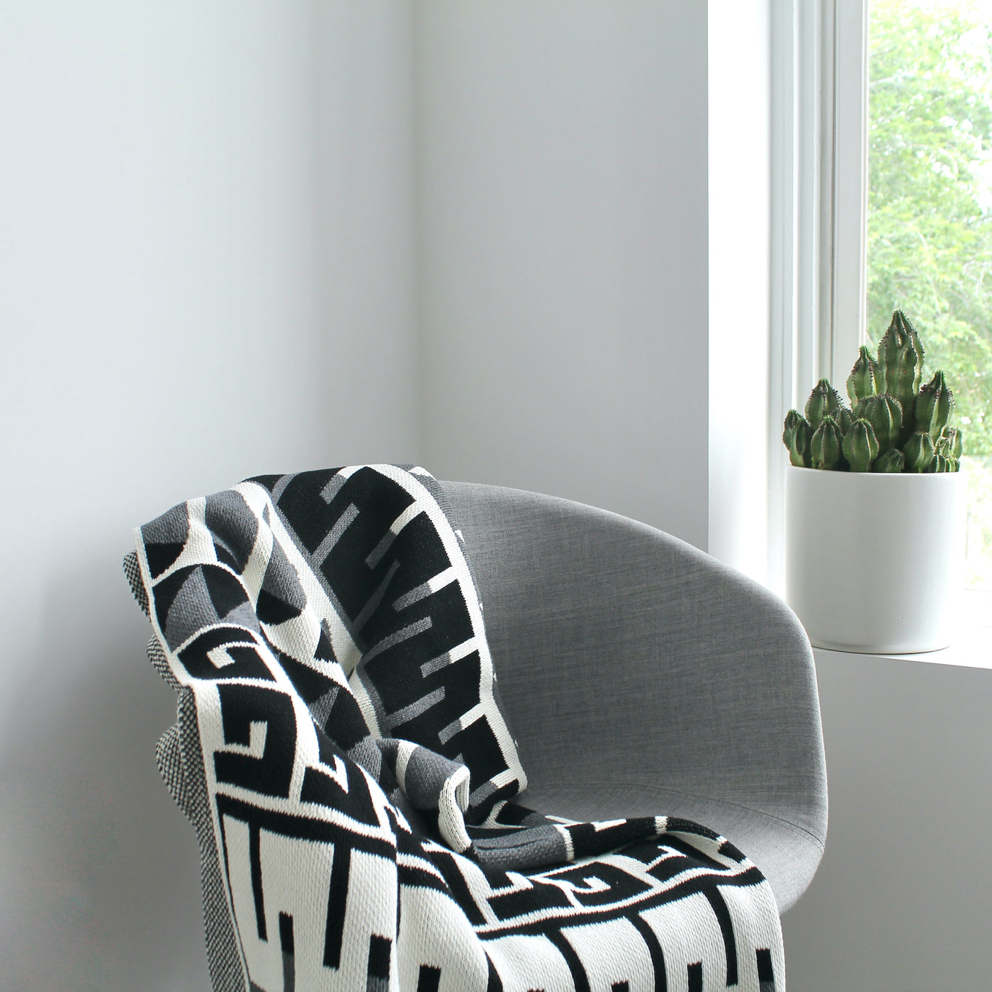 Scandinavian Pattern Throw on a Grey Chair 
