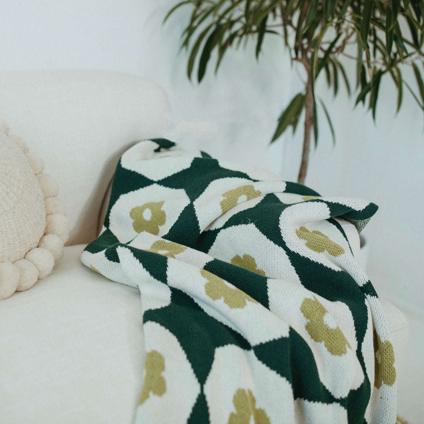 Green Throw Blanket on a White Sofa