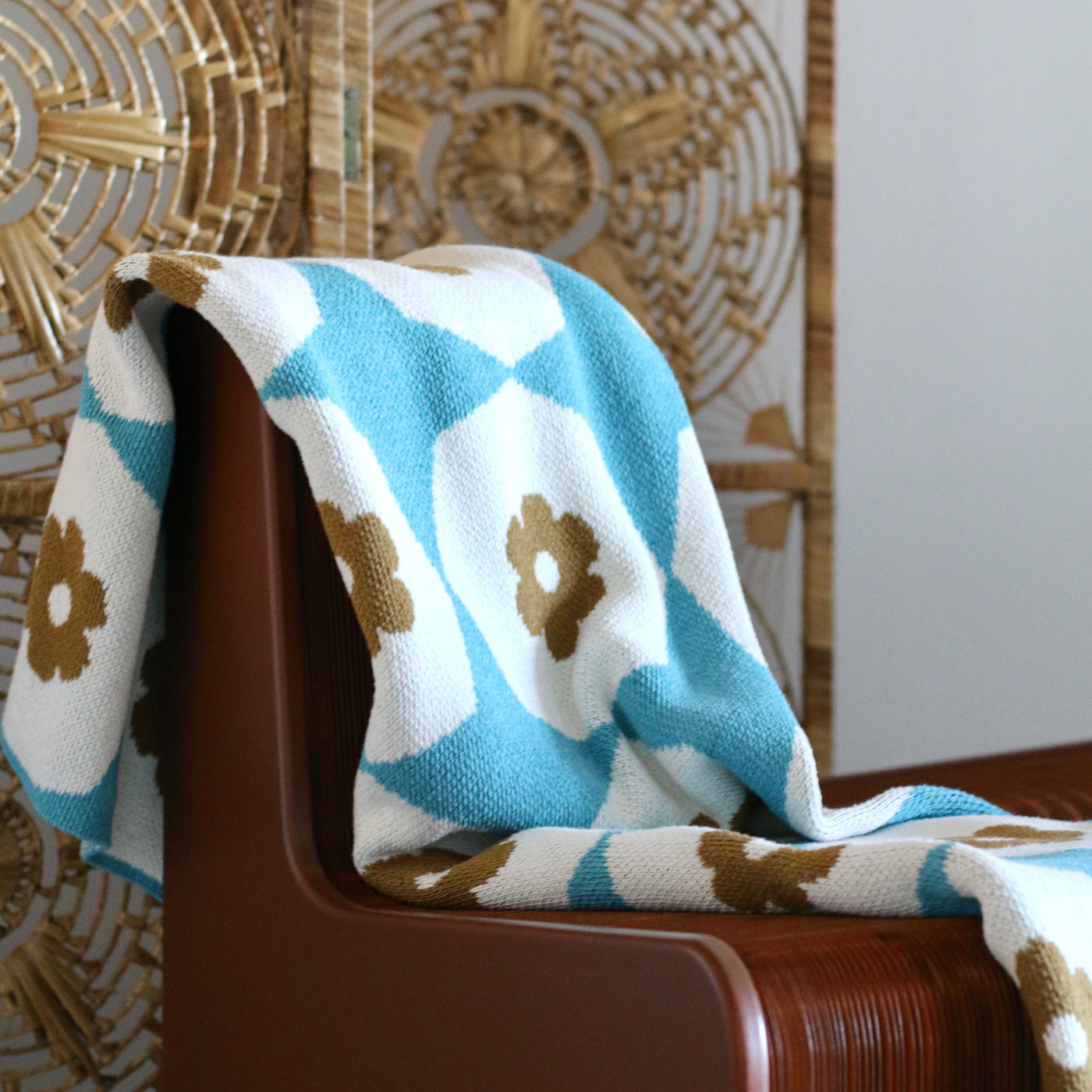 Turquoise and Gold Flower Tile Pattern Throw on Rattan Chair
