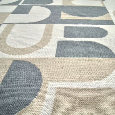 Close Up of Beige and Grey Arch Pattern Throw