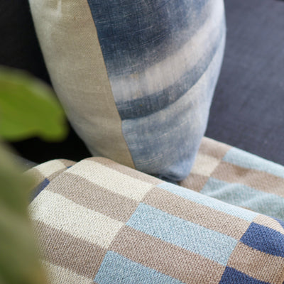 Taupe and Blue Cotton Throw on Blue Sofa