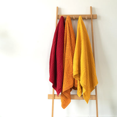 Sunset Colored Throws Hanging on a Coat Rack