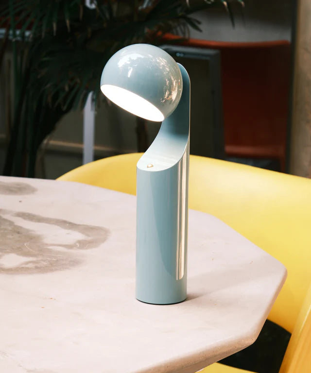 Blue lamp on a marble surface with a blurred background