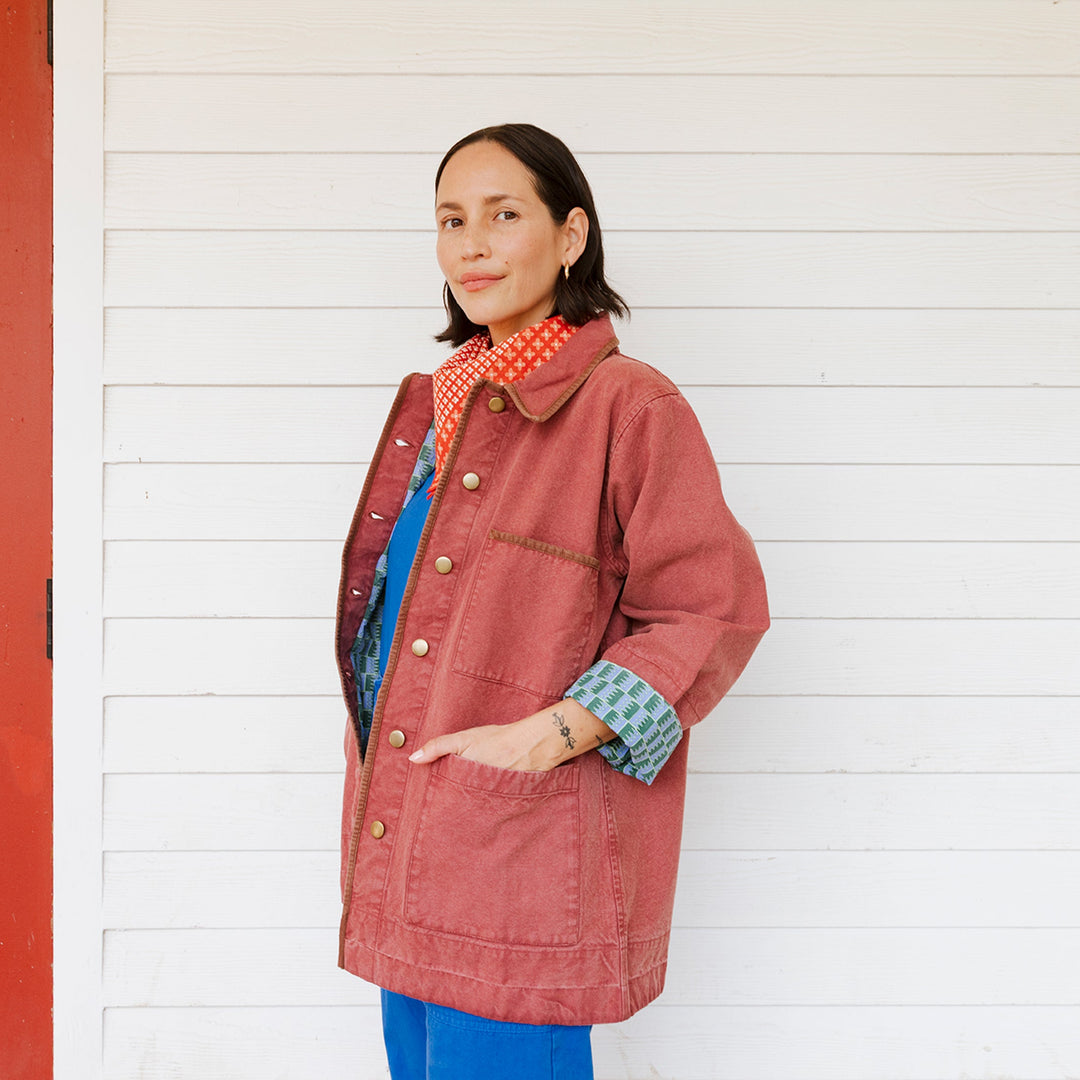 Woman wearing a red coat with a white background