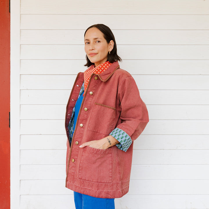 Woman wearing a red coat with a white background