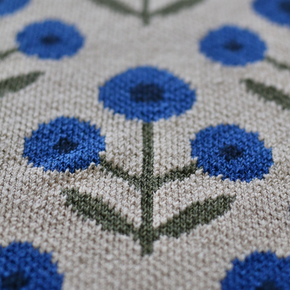 Close-up of a textured fabric with blue floral patterns