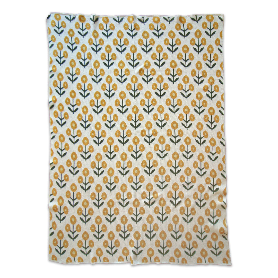 Floral patterned throw blanket with yellow flowers on a white background