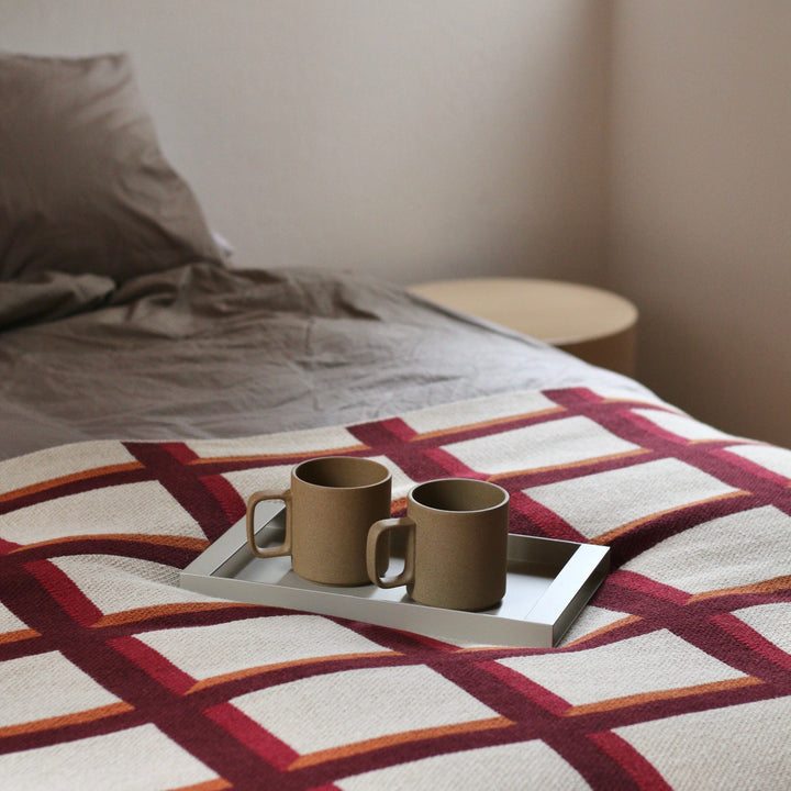 Modern Grid Cotton Throw in Bedroom with Coffee Cups