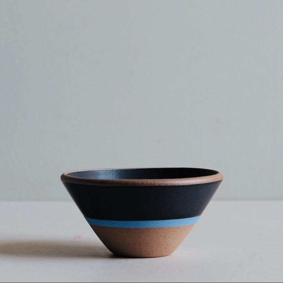 Ceramic bowl with a blue accent on a light gray background
