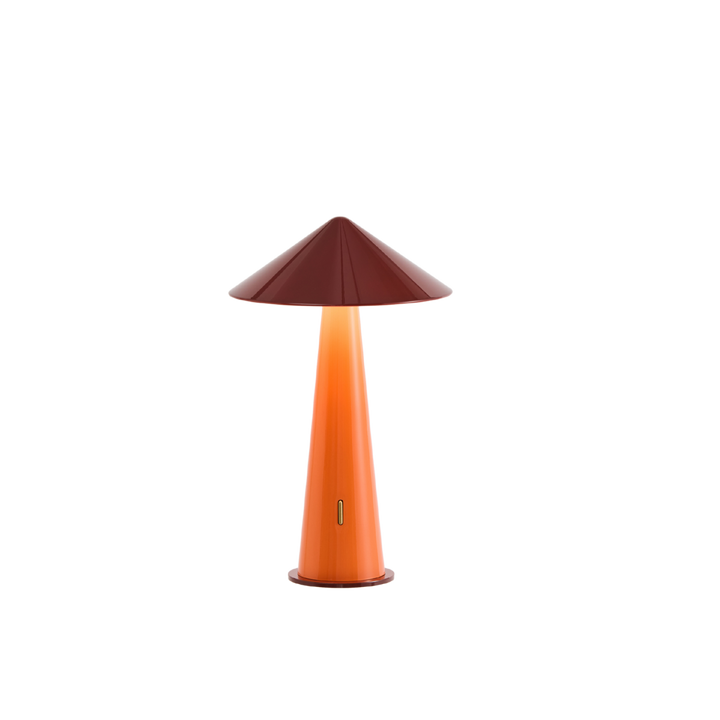 Table lamp with a dark red conical shade and orange cylindrical base on a white background