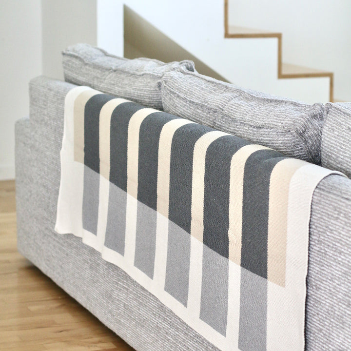 Modern Beige and Grey Throw on the back of a sofa