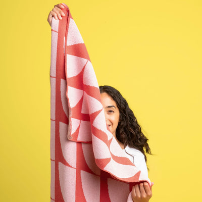 Girl holding up a Red and Pink Pattern Throw Blanket