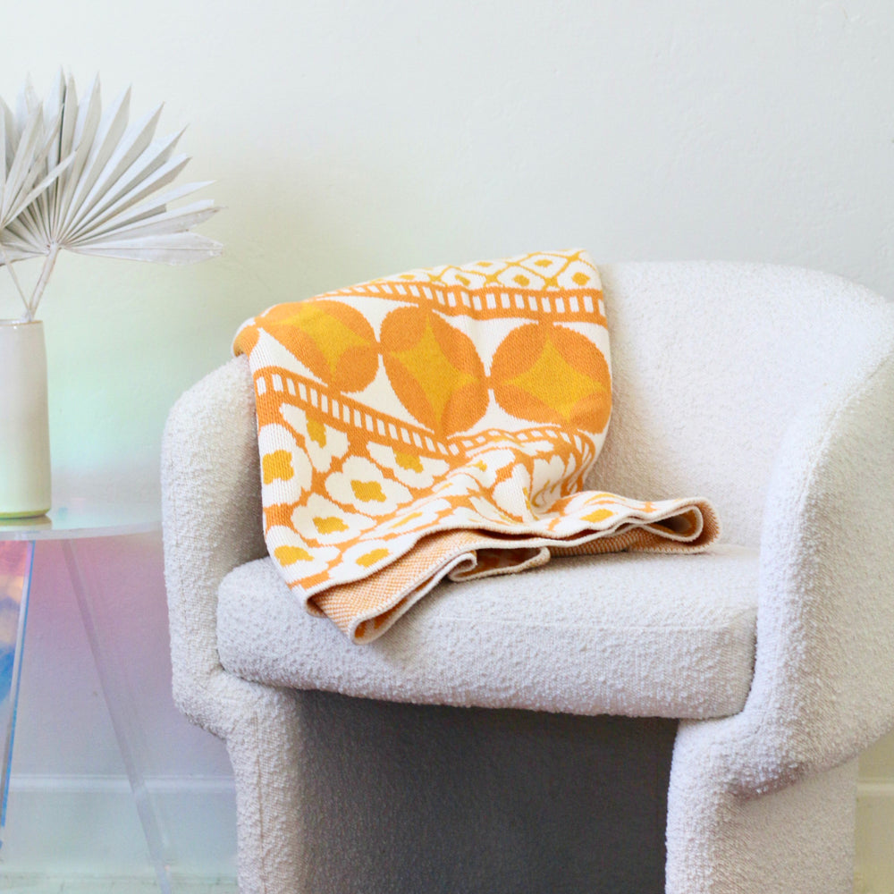 Yellow Flower Pattern Cotton Throw on a White Bouclé Chair