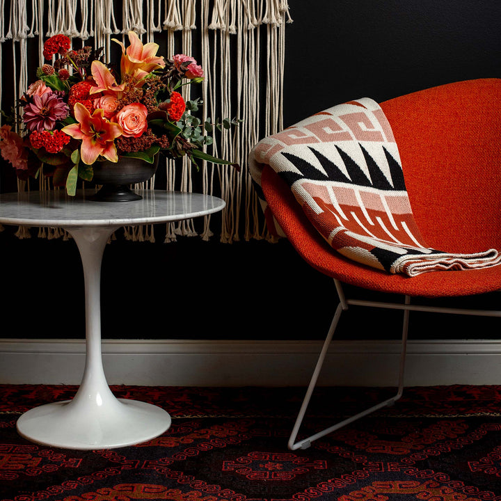 Terracotta and Blush Throw on Bertoia Diamond Chair in Orange